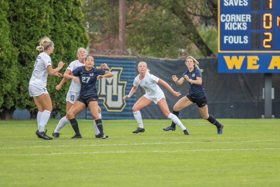 From left to right, Brianna Jaeger (7), Madison Burrier (13), and Bonnie Lacey (4) look to make a play on the ball against Utah State. 