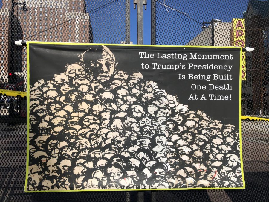 A pile of skeletons on a poster hangs on the fence outside of the Wisconsin Center, where a limited amount of events are occurring for the Democratic National Convention. 