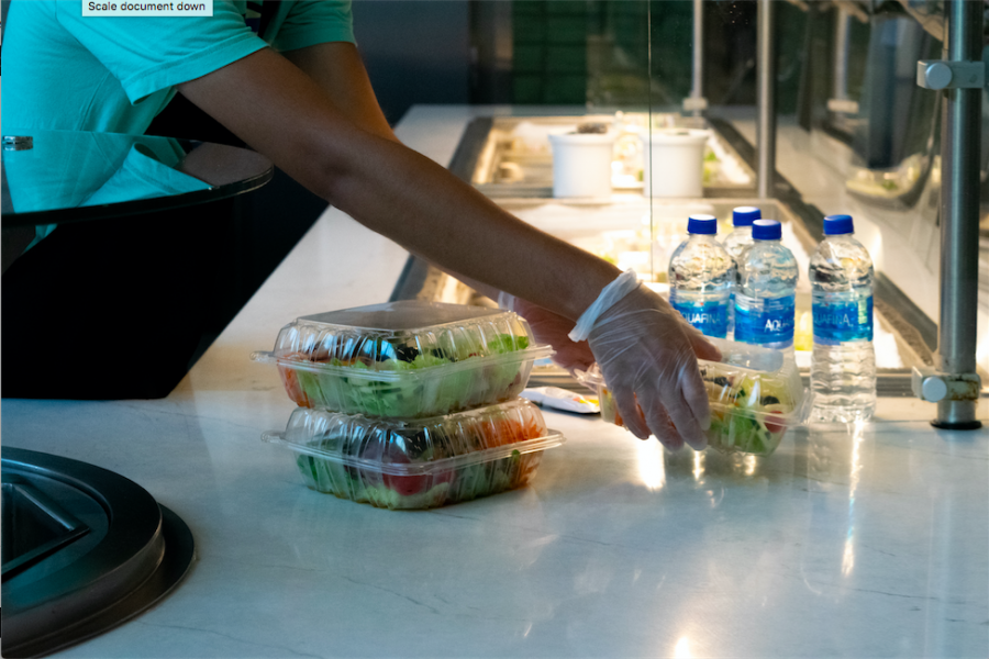 Dining hall staff prepare pre-packaged meals for students to grab-and-go.