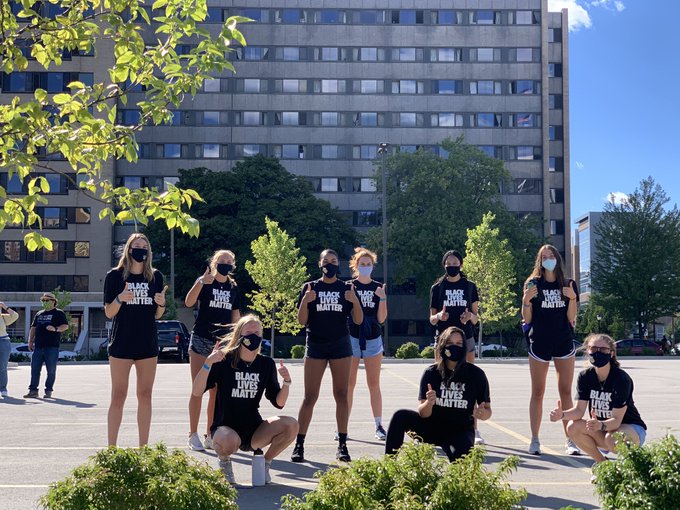 Savannah Rennie (far left) stands with the Marquette volleyball team prior to the athlete march Sept. 4. (Photo courtesy of Marquette Athletics.)
