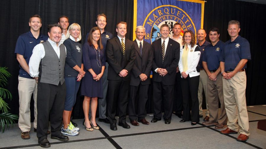 The Marquette coaches stand together at the press conference for then-new athletic director Bill Scholl in 2014.(Photo courtesy of Marquette Athletics.)