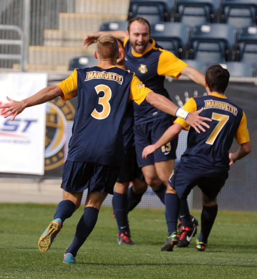 Dennis Holowaty (3) and Kelmend Islami (7) run to join Nick Parianos (13) in celebration after the Golden Eagles defeated Providence in the BIG EAST Tournament final in 2013. (Photo courtesy of Marquette Athletics.) 
