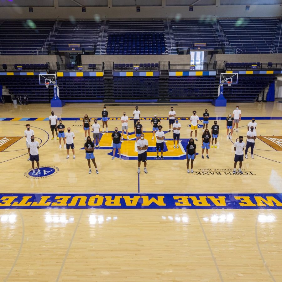 The Marquette mens and womens basketball teams stand together on the Al McGuire Center court Aug. 27. (Photo courtesy of Marquette Athletics.)