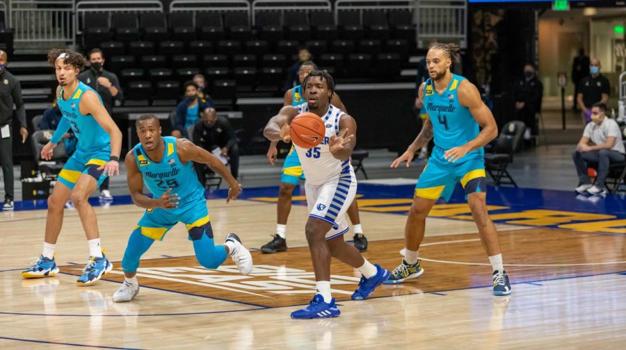 Dawson Garcia (33), Koby McEwen (25) and Theo John (4) play defense in Marquettes game against Eastern Illinois Nov. 27. (Photo courtesy of Marquette Athletics.)