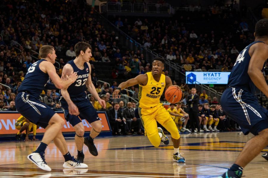 Koby McEwen (25) dribbles around Xavier defenders Jan. 15 at Fiserv Forum.