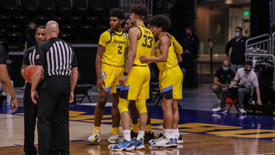 Justin Lewis (2) and Dawson Garcia (33) huddle with teammates during Tuesdays game against Oklahoma State (Photo courtesy of Marquette Athletics).