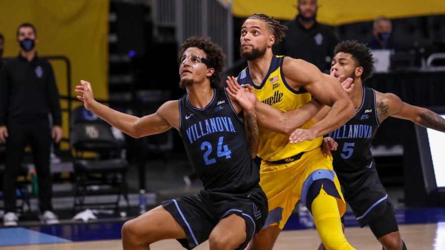 Jeremiah+Robinson-Earl+%2824%29+battles+Theo+John+%284%29+under+the+basket+in+Marquettes+loss+to+Villanova+at+Fiserv+Forum+Wednesday+night.+%28Photo+courtesy+of+Marquette+Athletics.%29