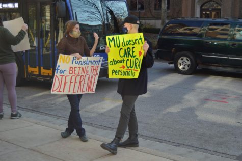 Community members protest the potential faculty lay offs during fall semester