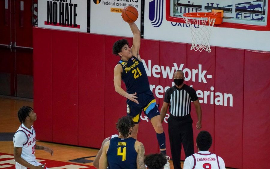 Sophomore guard D.J. Carton (21) dunks the ball against St. Johns on Jan. 16. Carton had 14 points, nine of which came in the second half (Photo courtesy of Marquette Athletics.)