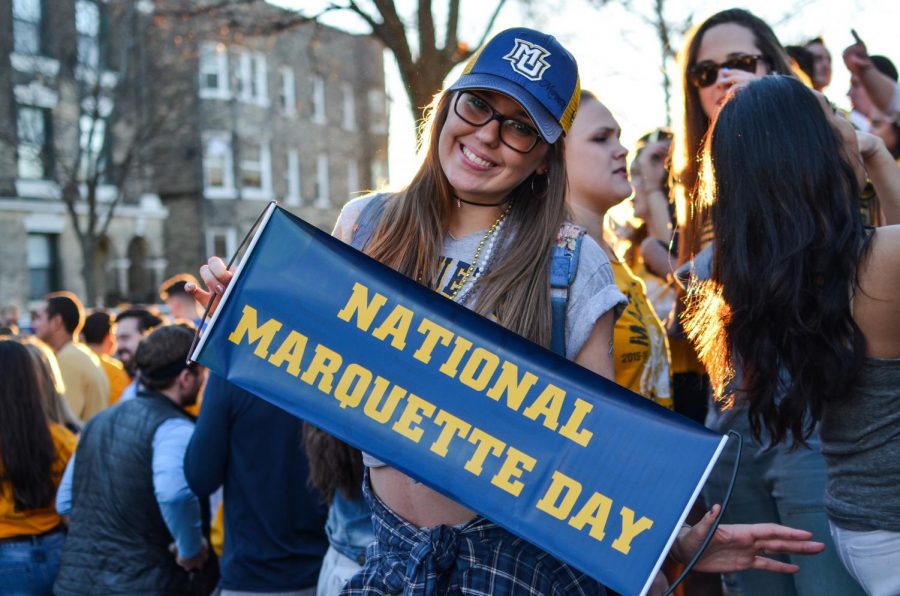 A Marquette student celebrates a past National Marquette Day