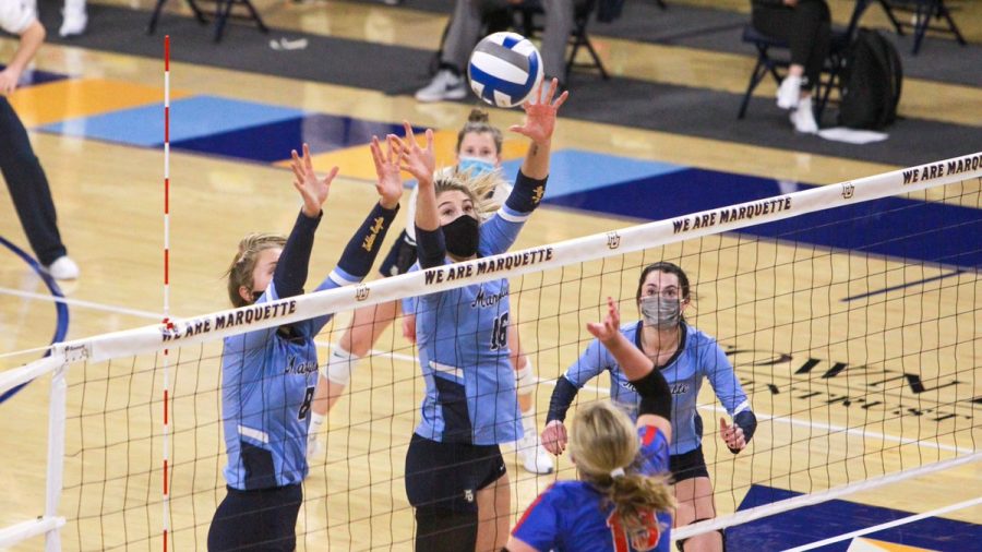 Senior outside hitter Hope Werch (8) and graduate student middle blocker Savannah Rennie (16) go for the block in Saturdays contest against the DePaul Blue Demons (Photo courtesy of Marquette Athletics.)