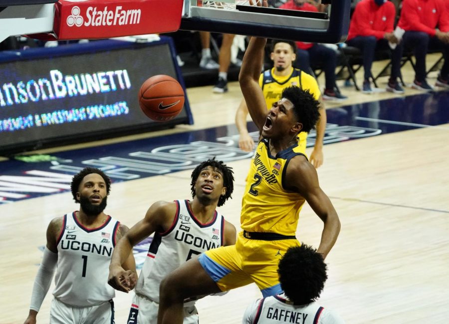 First-year+forward+Justin+Lewis+%282%29+throws+home+a+dunk+against+the+UConn+Huskies+on+Saturday+afternoon+%28Photo+courtesy+of+Marquette+Athletics.%29