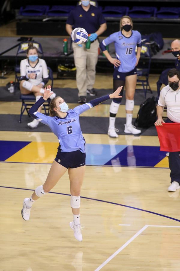 Megan Lund (6) attempts a serve in Marquettes sweep over DePaul Feb. 12. (Photo courtesy of Marquette Athletics.)