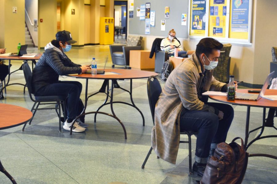 Students study at tables in the Alumni Memorial Union, following Marquettes social distancing guidelines.