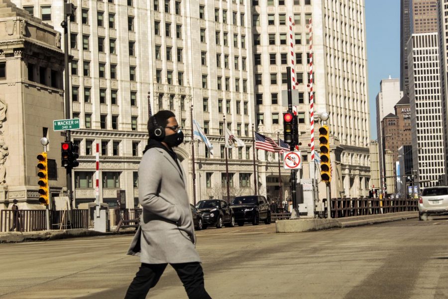 A pedestrian walks down a street in Chicago.