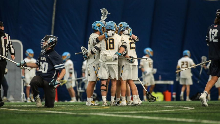 Redshirt junior attacker Griffin Fleming (18) huddles with teammates during the teams game against Villanova Feb. 27 (Photo courtesy of Marquette Athletics.)