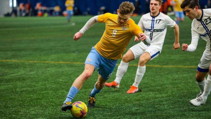 Lukas Sunesson (9) makes his way past the Creighton defense in the squads match with the Bluejays on Feb. 20. The junior forward had two goals in Saturday afternoons 3-1 win against the DePaul Blue Demons (Photo courtesy of Marquette Athletics.)