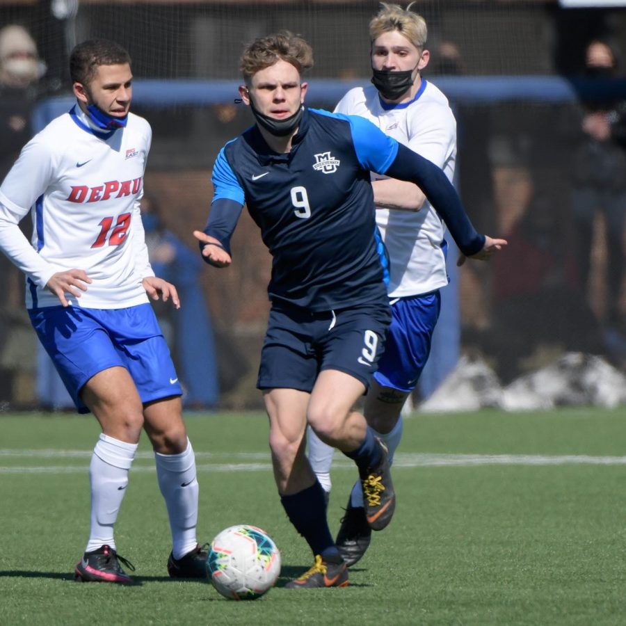 Junior forward Lukas Sunesson (9) strides past two DePaul defenders March 6 (Photo courtesy of Marquette Athletics.)