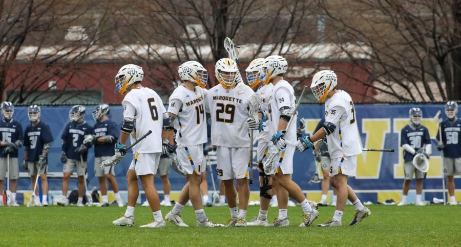 Redshirt first-year attacker Devon Cowan (29) talks with teammates during a game against the Georgetown Hoyas April 10. Cowan posted a hat trick Wednesday afternoon against St. Johns (Photo courtesy of Marquette Athletics.)