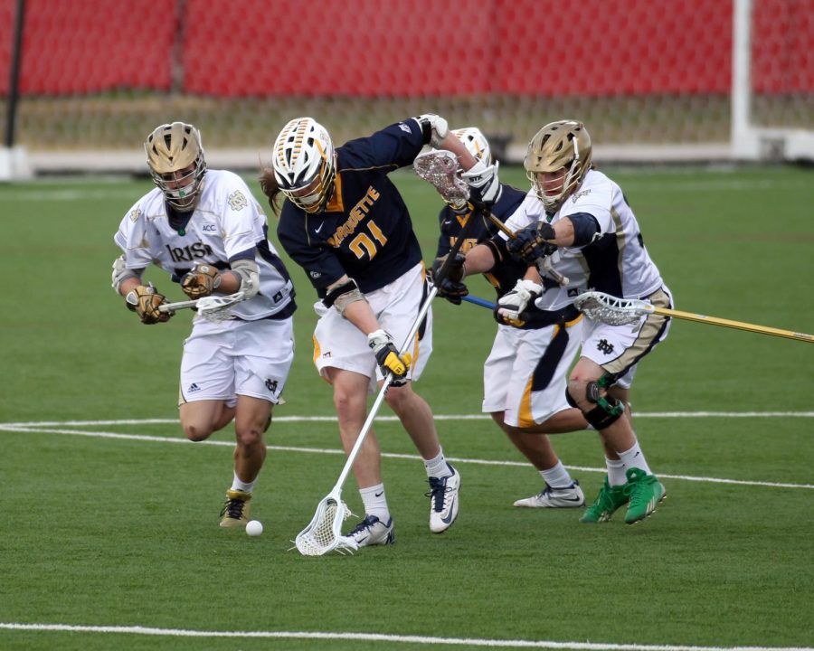 Liam Byrnes (21) goes for a ground ball in Marquettes 12-7 loss to Notre Dame April 8 2014. (Photo courtesy of Marquette Athletics.)