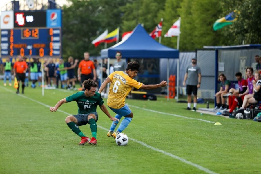 Edrey Caceres (6) makes a move on a University of Wisconsin-Green Bay defender in Marquettes 2-0 win Aug. 26. (Photo courtesy of Marquette Athletics.)