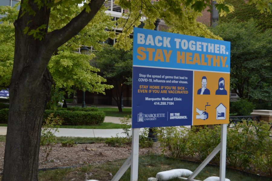 A COVID-19 health sign outside the Raynor Memorial Library. 