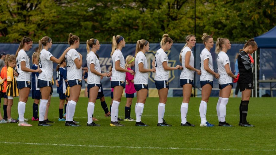 Marquette womens soccer stands at midfielder during the National Anthem prior to 1-0 win over Seton Hall Oct.3. (Photo courtesy of Marquette Athletics.)
