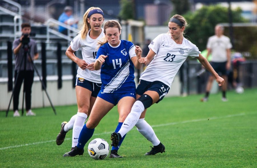 Rachel Johnson (23) and Alex Campana (19) fight for the ball in Marquettes 1-0 win over Seton Hall Oct. 3. 