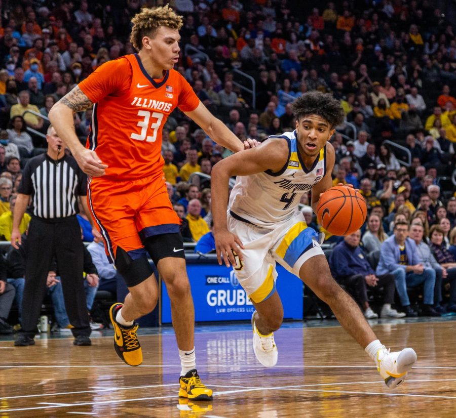 First-year guard Stevie Mitchell (4) drives through the paint in Marquette mens basketballs 67-66 win over No. 10 Illinois Nov. 15. 