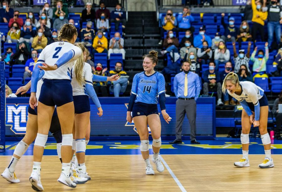Redshirt Sophomore Carly Skrabak (14) and graduate student Hope Werch (8) celebrate with their teammates after gaining a point. The Golden Eagles lost to the Bluejays 3-1 on October 29, 2021 at the Al McGuire Center (COLLIN NAWROCKI/Marquette Wire)
