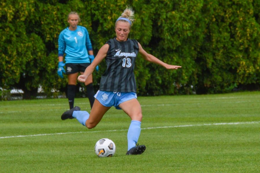 Redshirt junior defender Madison Burrier (13) takes a free kick in Marquette womens soccers 1-0 loss to Notre Dame Aug. 26.  