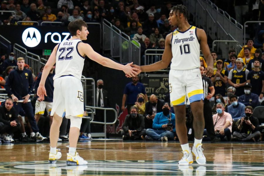 Redshirt first-year guard Tyler Kolek (22) and redshirt first-year forward Justin Lewis (10) high-five each other in Marquette mens basketballs 67-66 win over No. 10 Illinois Nov. 15. 