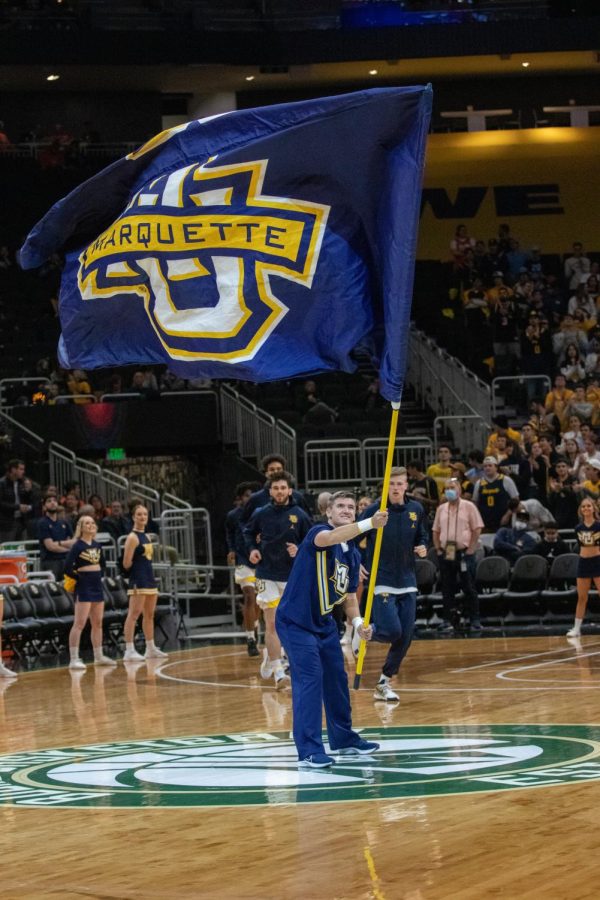 Marquette flag being waved during mens basketballs 67-66 win over No. 10 Illinois Nov. 15. 