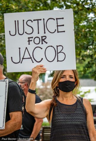 A woman holds a Justice for Jacob sign at a 2020 Columbus protest. A Photo via Flickr