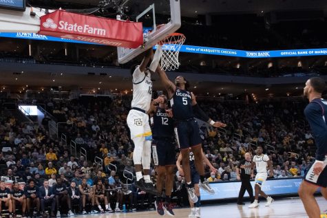 Redshirt first-year forward Olivier-Maxence Prosper finishes off a dunk in Marquette mens basketballs 78-70 loss to UConn Dec. 21. 