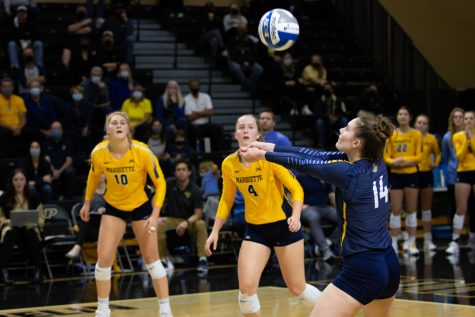 Redshirt sophomore Carly Skrabak (14) passes the ball in Marquette volleyballs 1-3 loss to Dayton in the First Round of the NCAA Tournament Dec. 2. 