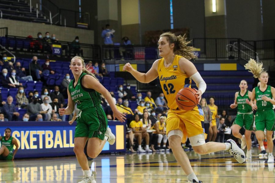 Graduate student forward Lauren Van Kleunen (42) dribbles the ball in Marquette womens basketballs 89-65 win over North Dakota Dec. 11. 