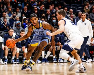 Redshirt first-year forward Justin Lewis drives to the basket in Marquette mens basketballs 57-54 upset win over No. 11 Villanova Jan. 19. (Photo courtesy of Marquette Athletics.) 