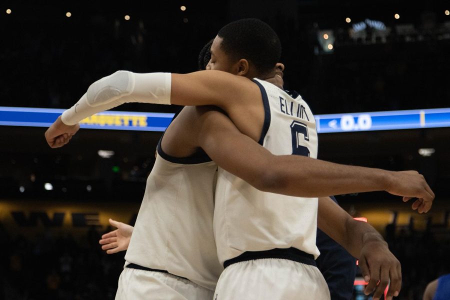 Redshirt first-year forward Justin Lewis (left) and redshirt junior guard Greg Elliott (right) hug after Marquette mens basketball defeated No. 20 Seton Hall Jan. 15. 