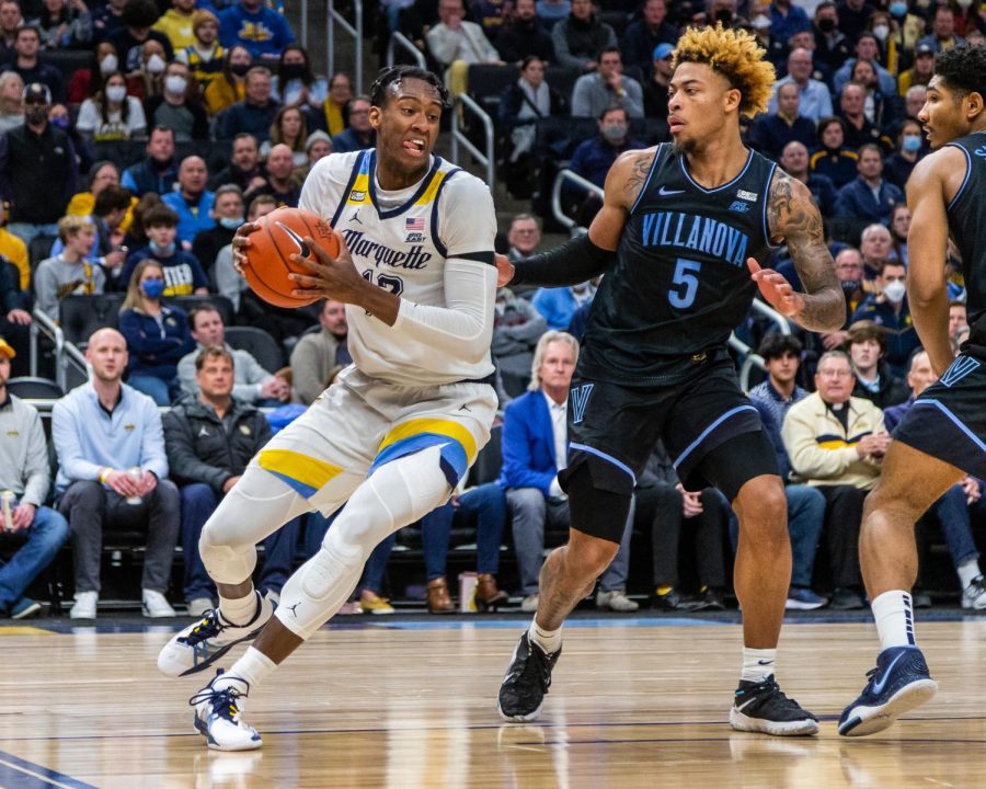 Redshirt first-year forward Olivier-Maxence Prosper (12) heads to the basket in then-No. 24 Marquette mens basketballs 83-73 win over then-No. 12 Villanova Feb. 2. 