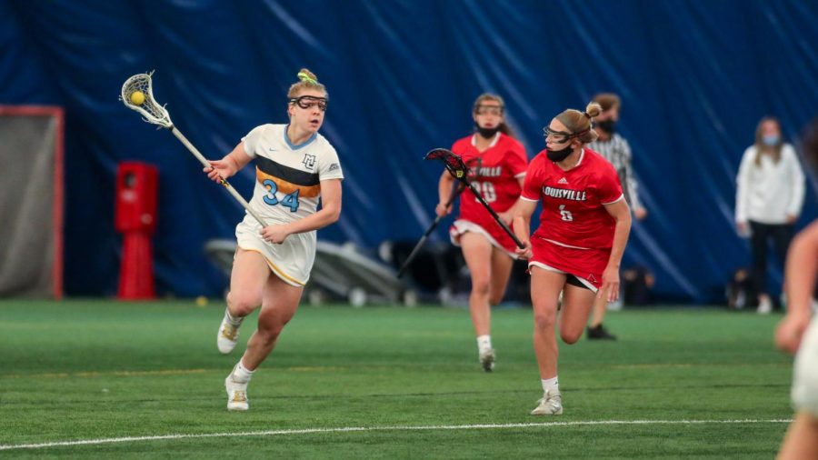 Junior defender Ellie Henry in Marquette womens lacrosses 14-10 loss to Louisville March 14 2021. (Photo courtesy of Marquette Athletics.)