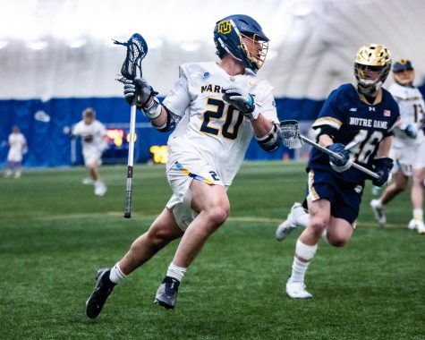 Redshirt sophomore face-off specialist Cole Emmanuel running with the ball in Marquettes 18-8 loss to Notre Dame April 12. 