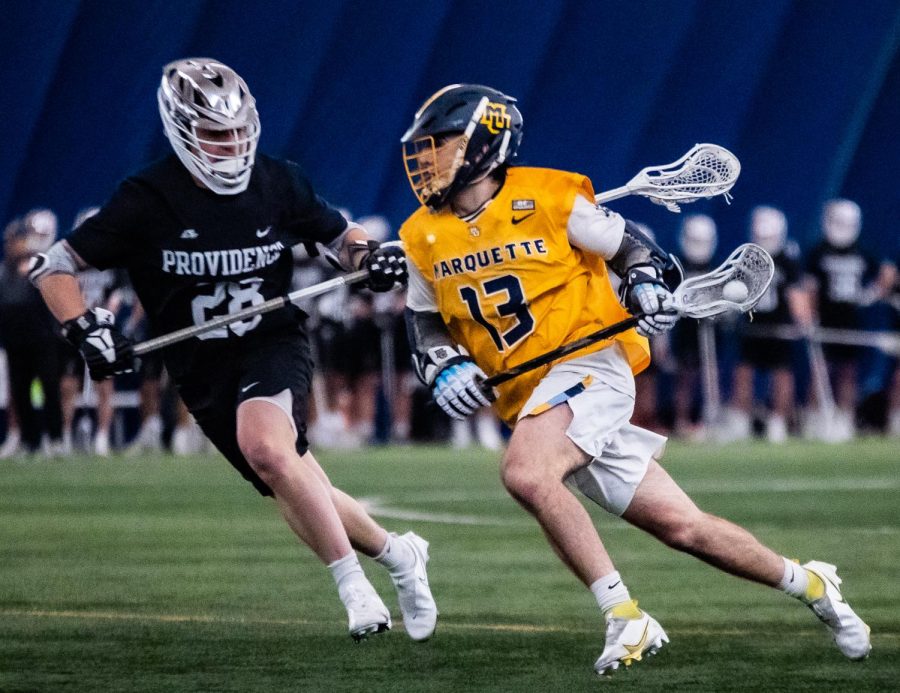 First-year attacker Bobby OGrady (13) running with the ball in Marquettes 16-11 win over Providence April 2. 