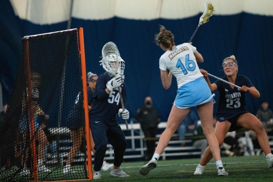 First-year attacker/midfielder Elise Smigiel (16) takes a shot on net in Marquette womens lacrosses 19-14 win over Villanova April 9. 