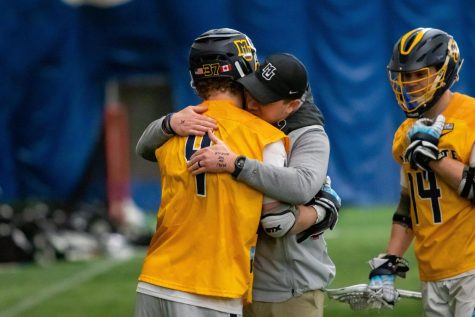 Marquette mens lacrosse redshirt sophomore face-off specialist hugs head coach Andrew Stimmel prior to the teams 16-11 win over Providence April 2. 
