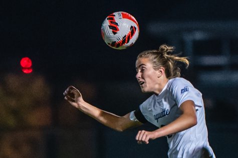 Junior forward Elsi Twombly attempts a header in Marquette womens soccers 2-2 draw against Providence Oct. 13. 