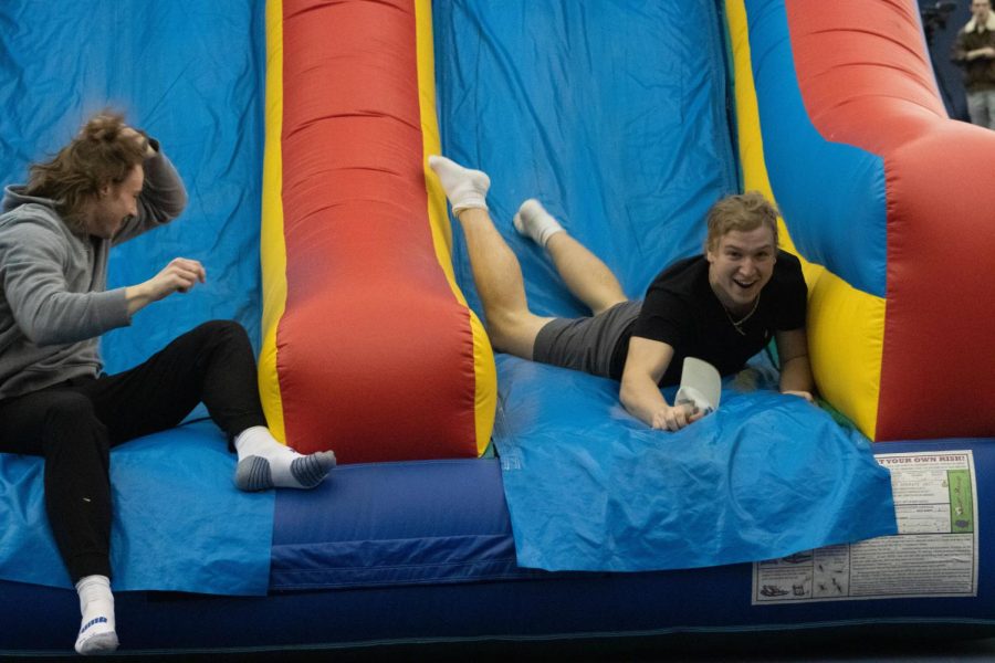 Students slide down the blow up obstacle course during Rock the Rec on Saturday December 3, 2022.