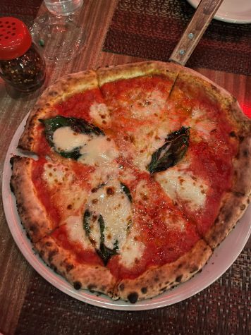 The margherita pizza featured a classic sauce with mozzarella and fresh basil, finished with a dash of olive oil.