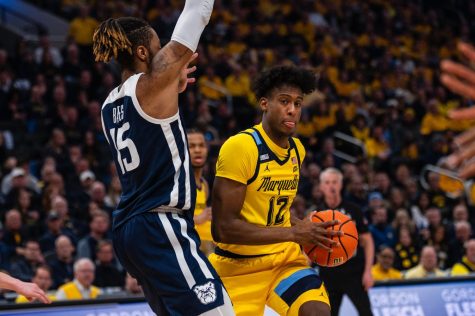Junior forward Olivier-Maxence Prosper (12) drives to the basket in Marquette’s win over Butler Feb. 4 at Fiserv Forum. (Marquette Wire Stock Photo)
