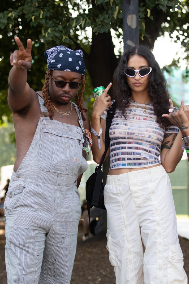 Nnamdi wore gray Carhartt overalls and a blue bandana, sunglasses and gold jewelry. Yasmine was in cream colored parachute cargo pants and a colorful stripey top, complete with black and white sunglasses. Both are members of the band Sen Morimoto.